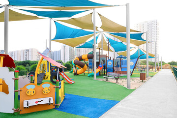 View of children's playground with benches in city