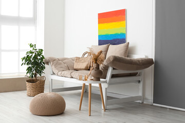 Interior of light living room with rainbow painting and couch