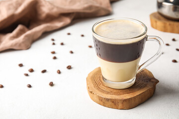 Glass cup of delicious Cafe Bombon on light table