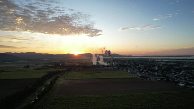 Spectacular sunrise and sunset at Proserpine Queensland Australia with sugar mill in full operation in the background