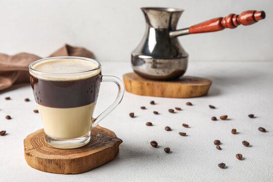 Glass cup of delicious Cafe Bombon on light table