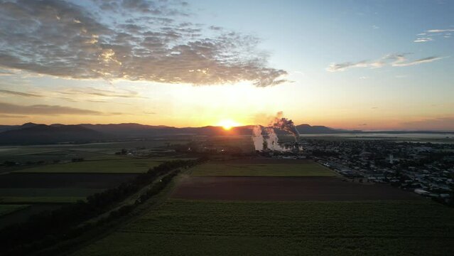 Spectacular sunrise and sunset at Proserpine Queensland Australia with sugar mill in full operation in the background