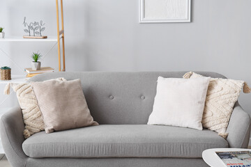 Soft pillows on grey sofa in living room