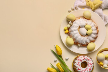 Composition with tasty Easter cakes, painted eggs and tulip flowers on color background