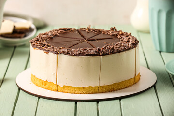 Tasty birds milk cake on color wooden table