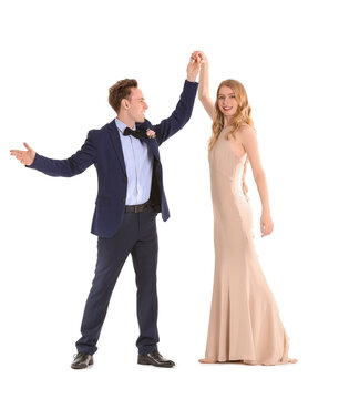 Beautiful couple dressed for prom dancing on white background