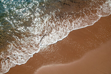 Сlear ocean wave on sandy beach, sea ​​wave texture, unusual water background