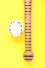 Wooden baseball bat and ball on yellow background, flat lay. Sports equipment