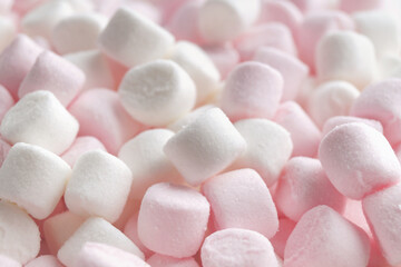 Fototapeta na wymiar Delicious puffy pink and white marshmallows as background, closeup