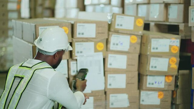 A male worker inspects item stock with a barcode scanner in a vast warehouse in a Logistics Center. warehouse worker, working, checklist, counting, Distribution Warehouse