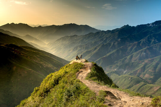 Hiking tourists explore the trail on spine and the top of the mountains Ta Xua. This is a very popular tourist destination in VN