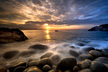 Long exposure of sea and stones, beautiful sunrise in Quy Nhon city, Vietnam