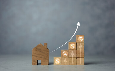 Interest rate financial and mortgage rates concept. House with a wooden block with icon percentage...