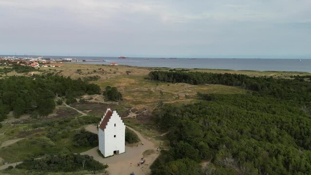 Aerial Orbit of Den Tilsandede Church and Skagen Town and Grassland, Denmark