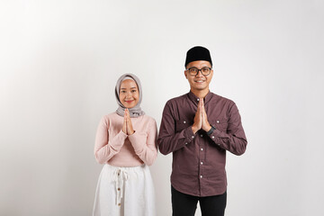 Asian Muslim couple greeting gesture on Ramadhan isolated on white background