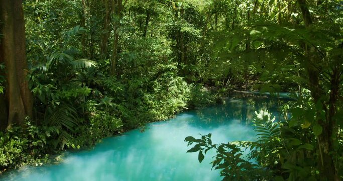 Vivid turquoise blue Rio Celeste river through lush green Costa Rica jungle