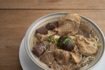 Duck noodles in bowl on wooden table  Thai food.