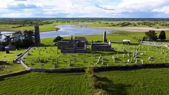 A pull back drone shot of The River Shannon backdrop to the Ancient  Clonmacnoise Monastery  in County Offaly Ireland