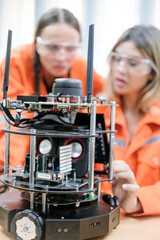 Multiracial tachnicial engineer training with robot arm