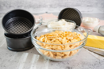 Cheesecake recipe. Three mini round cake pans (tin, mould), and fresh ingredients for the...