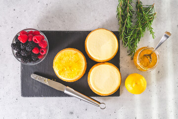 Mini cheesecakes, orange marmalade, rosemary, and berries. Decorating cheesecakes