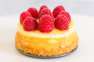 Mini cheesecake with raspberries close-up. Homemade delicious dessert, breakfast, sweet holiday treat