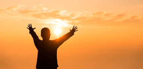 Silhouette of woman raising her hand praying spirituality and religion, banner and copy space of female worship to god. Christianity religion concept.Christians person are pray humility humble to god.