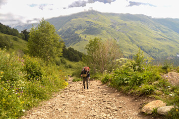 Fototapeta na wymiar Path of Cheget. There is a man walking up to the path. There are mountain and valley on the background.