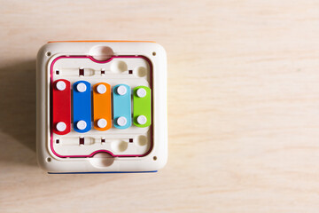 Colorful xylophone box with flat lay wooden floor background