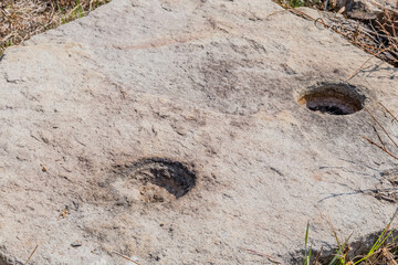 Flat boulder with post holes used in ancient stone fortress in Yeosu, South Korea.