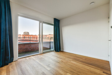 an empty room with wood floors and sliding glass doors looking out onto the cityscapearrons com