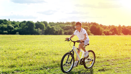 Obraz premium a boy rides a bicycle in nature