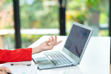 Woman working at home office hands on keyboard close-up