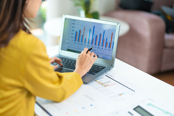 business woman using laptop or notebook computer with data analysis graph dashboard, confident woman working with computer laptop concept, contact idea design dashboard graph business conceptual.