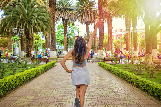 Soaking up the sun in the park: a dark-haired Latina woman on vacation in Tarija