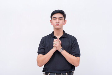A young asian man with a submissive eyes pleading for forgiveness. Sincerely regretful and looking for penance. Isolated on a white backdrop.