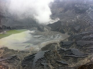 crater in the mountains with a pool of water