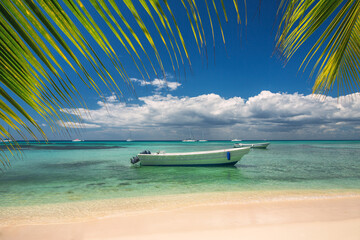 Caribbean sea and boat on the shore, beautiful panoramic view from the island beach