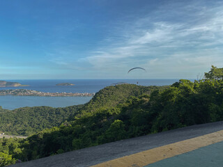 Popular tourist attraction in Rio de Janeiro for panoramic city skyline views is paragliding from...