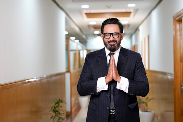 Indian businessman giving namaste or welcome gesture