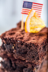 Brownie with orange slice on a light background
