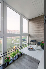 large spacious glazed balcony loggia in the apartment with a gorgeous view of the sunny city