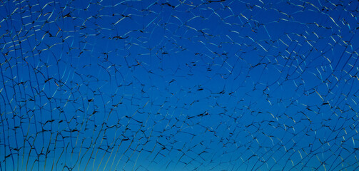 Dark blue broken shattered glass with black cracks