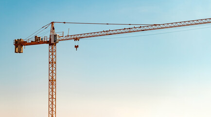 Construction crane in front of cloudless sunny blue sky - Powered by Adobe