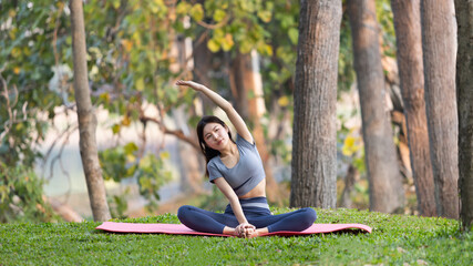 Asian woman doing yoga in nature in the forest, Meditation and breathing exercises, Treat ADHD and train your mind to be calm, Healthy exercise, Mindfulness, Homeopathy, Park yoga.