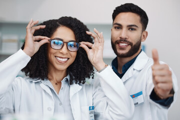 Pharmacy workers, portrait and thumbs up of pharmacist, healthcare and wellness staff with glasses....