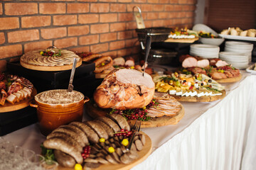 Catering table background. Wedding venue meat snacks. Various meat food background. Fatty lard in ceramic jar and piece of pig. Pork slicing. Tasty food background. Meat party snack.