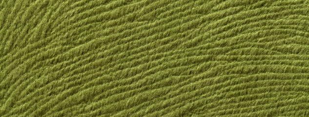 Texture of dark green textile background from a soft wool material, macro. Fabric with olive wavy pattern.