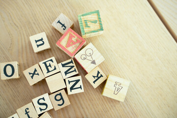 Toys children and learning,Wooden cubes with numbers and colorful toy bricks on a wooden background.