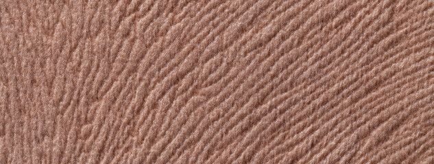 Texture of dark brown textile background from a soft wool material, macro. Fabric with umber wavy pattern.